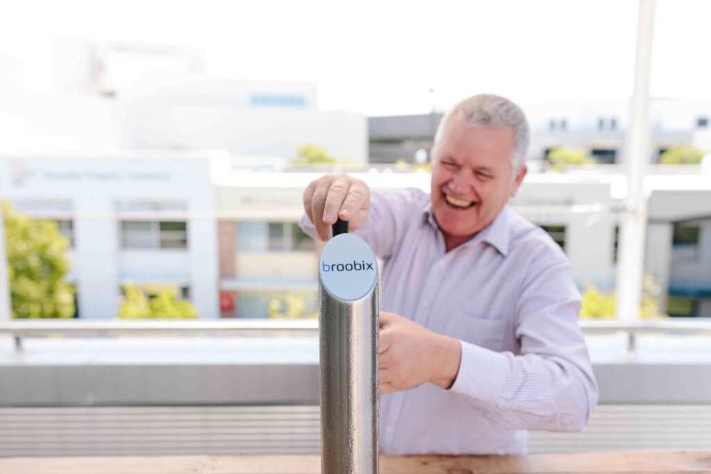 man pouring pint of beer in outdoor office bar